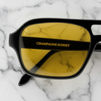 Champagne Sunset sunglasses, close up studio view on marble background