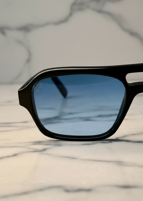 Ocean Breeze blue lens sunglasses by Valenti Exclusive, front close up view on marble background